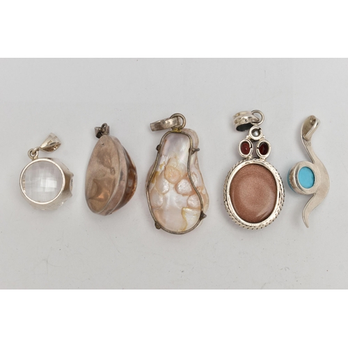 67 - FIVE STATEMENT PENDANTS, a selection of white metal pendants, set with pearl, shell, goldstone and i... 