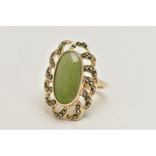 84 - A YELLOW METAL JADE DRESS RING, of a large oval form, set to the centre with an oval cut jade caboch... 