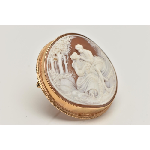 85 - A 9CT GOLD CAMEO BROOCH, of a circular form, carved shell cameo depicting a couple scene, collet set... 