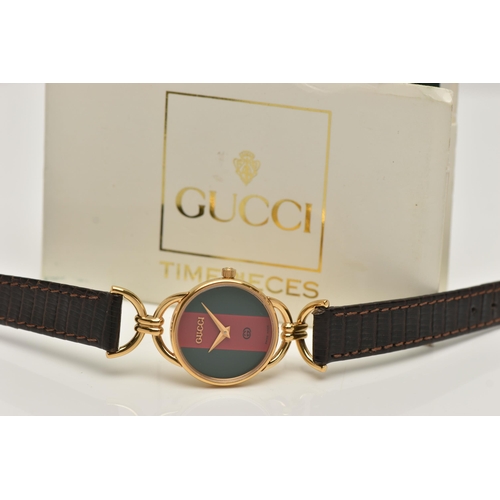 90 - A 'GUCCI' WRISTWATCH, quartz movement, red and green round dial, signed 'Gucci', yellow metal case, ... 