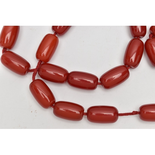 272 - A RED PLASTIC BARREL BEAD NECKLACE, designed with a single row of thirty-five barrel shape beads, ea... 