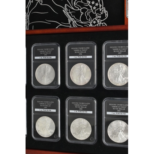 273 - A CASED SET OF 37 USA SILVER EAGLE COINS, each of the coins are individually slabbed and uncirculate... 