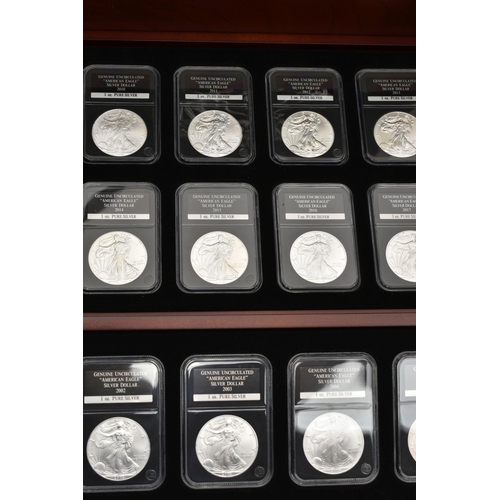 273 - A CASED SET OF 37 USA SILVER EAGLE COINS, each of the coins are individually slabbed and uncirculate... 