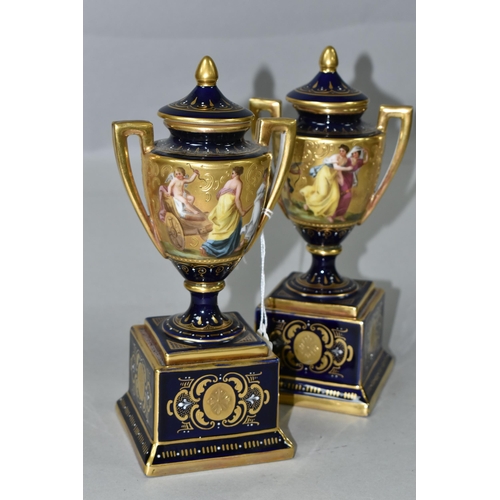 376 - A PAIR OF VIENNA STYLE PORCELAIN TWIN HANDLED PEDESTAL  VASES WITH COVERS, cobalt blue and gilt grou... 