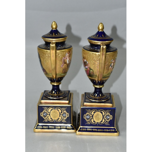 376 - A PAIR OF VIENNA STYLE PORCELAIN TWIN HANDLED PEDESTAL  VASES WITH COVERS, cobalt blue and gilt grou... 