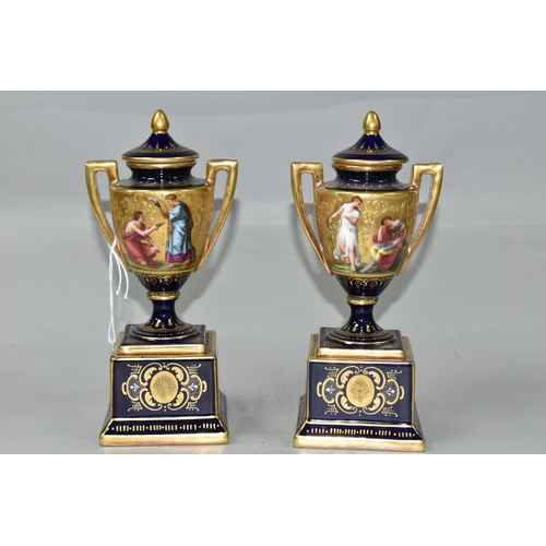 376 - A PAIR OF VIENNA STYLE PORCELAIN TWIN HANDLED PEDESTAL  VASES WITH COVERS, cobalt blue and gilt grou... 