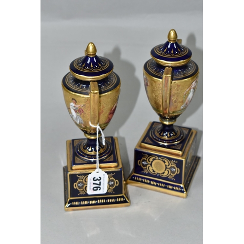 376 - A PAIR OF VIENNA STYLE PORCELAIN TWIN HANDLED PEDESTAL  VASES WITH COVERS, cobalt blue and gilt grou... 