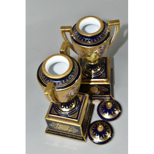 376 - A PAIR OF VIENNA STYLE PORCELAIN TWIN HANDLED PEDESTAL  VASES WITH COVERS, cobalt blue and gilt grou... 