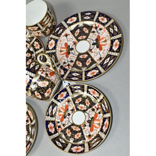 386 - TWO ROYAL CROWN DERBY IMARI 2451 TRIOS, comprising two teacups, two saucers, and two 18cm tea plates... 