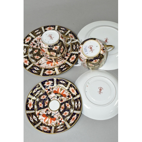 386 - TWO ROYAL CROWN DERBY IMARI 2451 TRIOS, comprising two teacups, two saucers, and two 18cm tea plates... 