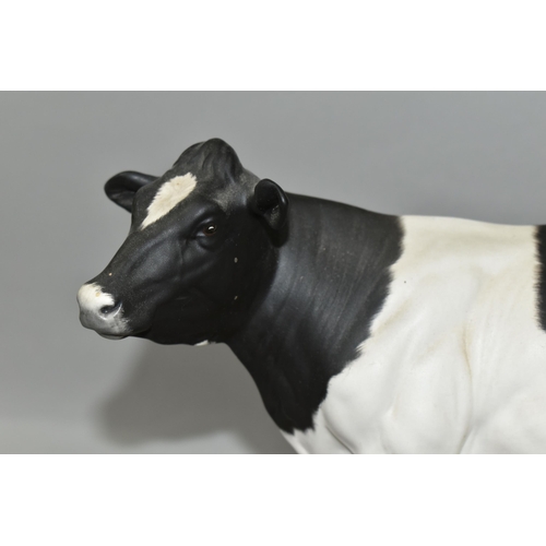 393 - A ROYAL DOULTON FRIESIAN COW, standing on a wooden plinth, model no A2607, height including plinth 2... 