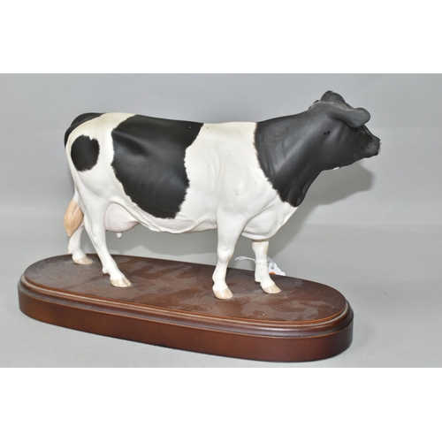 393 - A ROYAL DOULTON FRIESIAN COW, standing on a wooden plinth, model no A2607, height including plinth 2... 