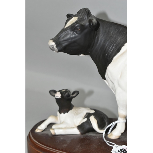 396 - A ROYAL DOULTON FRIESIAN COW AND CALF, standing on a wooden plinth, model no A2607/2690, height incl... 