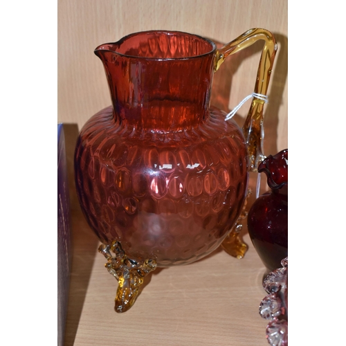 398 - A GROUP OF CRANBERRY GLASS, comprising a graduating clear to pink jug, with amber glass handle and t... 