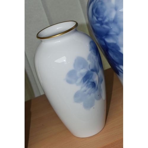 405 - THREE JAPANESE OKURA PORCELAIN VASES, decorated with blue roses on a white ground, heights 22cm, 23c... 