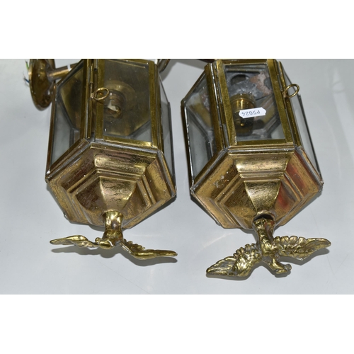 482 - A PAIR OF BRASS ELECTRIC WALL LIGHTS, in the style of Victorian coach/carriage lanterns with brass e... 