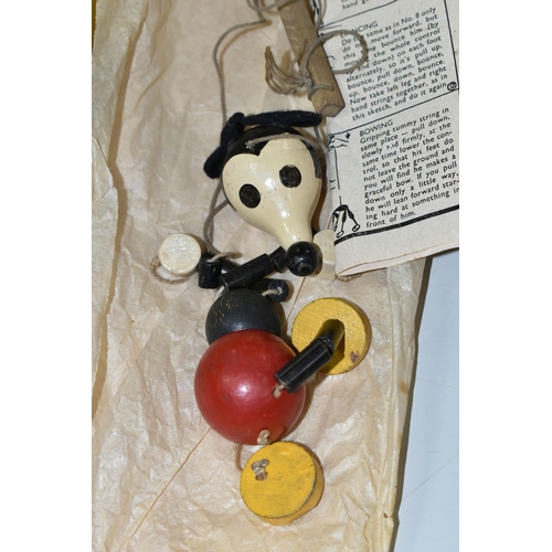 489 - A BOXED PELHAM PUPPET COWGIRL, AND A SMALL MICKEY MOUSE STRING PUPPET, both of painted wood construc... 