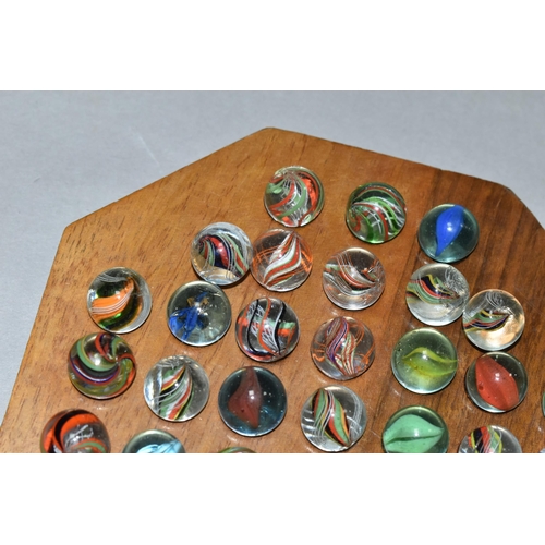 490 - A SOLITAIRE BOARD WITH VINTAGE/ANTIQUE MARBLES, the wooden board containing thirty three handmade ma... 