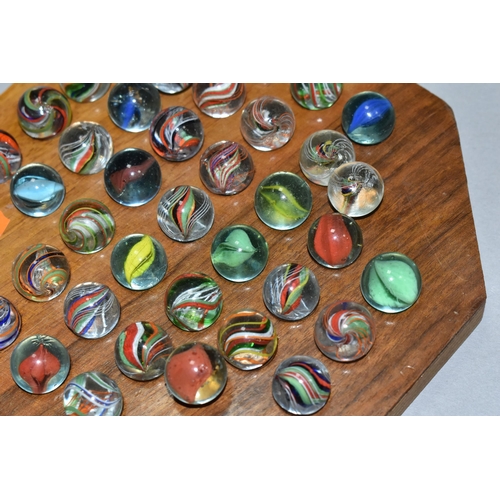 490 - A SOLITAIRE BOARD WITH VINTAGE/ANTIQUE MARBLES, the wooden board containing thirty three handmade ma... 