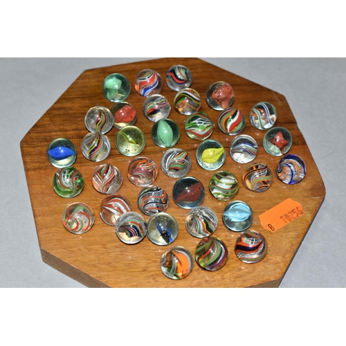 490 - A SOLITAIRE BOARD WITH VINTAGE/ANTIQUE MARBLES, the wooden board containing thirty three handmade ma... 