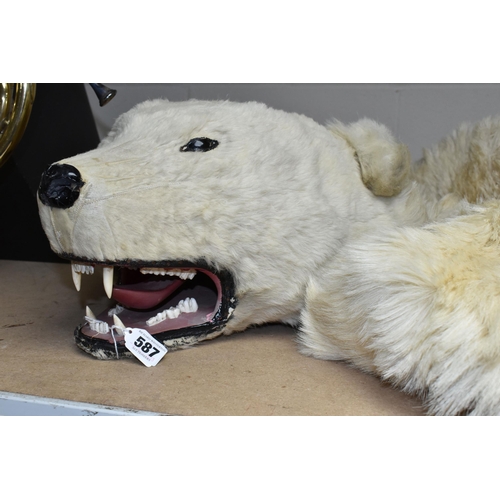 587 - TAXIDERMY IN THE FORM OF A  POLAR BEAR, glass eyes, nose damaged, wooden head, on a fabric lining (1... 