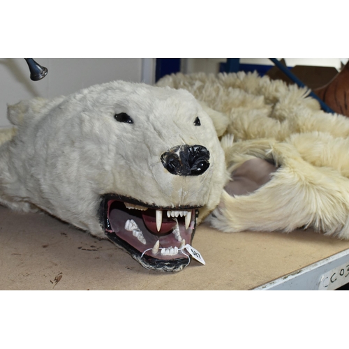 587 - TAXIDERMY IN THE FORM OF A  POLAR BEAR, glass eyes, nose damaged, wooden head, on a fabric lining (1... 