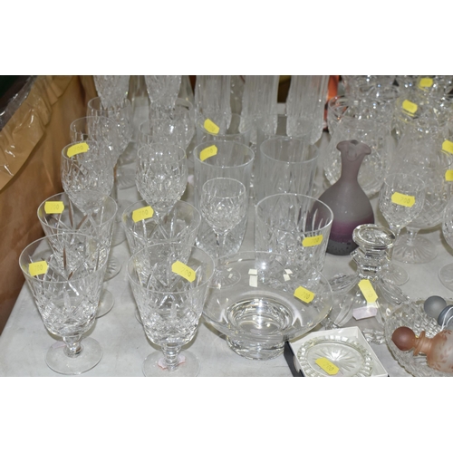 700 - A GROUP OF STUART CRYSTAL DRINKING GLASSES AND VASE, comprising a large lily vase, a set of six smal... 