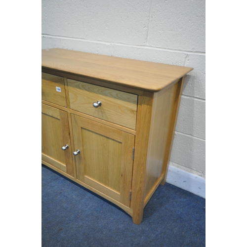 1300 - A MODERN LIGHT OAK SIDEBOARD, with two drawers, over double cupboard doors, width 98cm x depth 43cm ... 