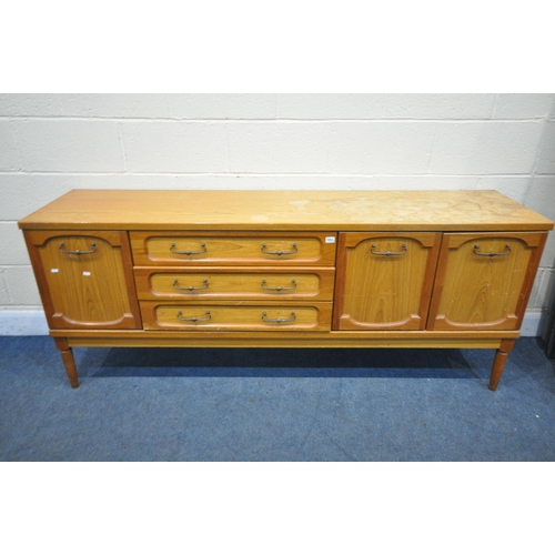 1311 - A MID CENTURY TEAK SIDEBOARD, with an arrangement of drawers and cupboard doors, on cylindrical legs... 