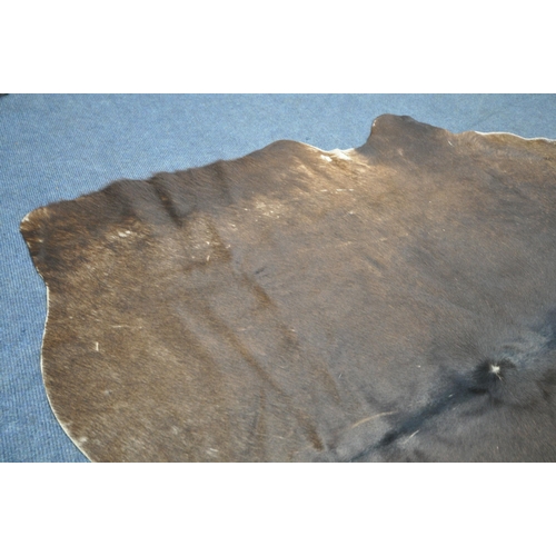 1320 - A HANLIN SOUTH AMERICAN NATURAL COWHIDE RUG, 160cm x 171cm (condition:-stitched repair to one area, ... 