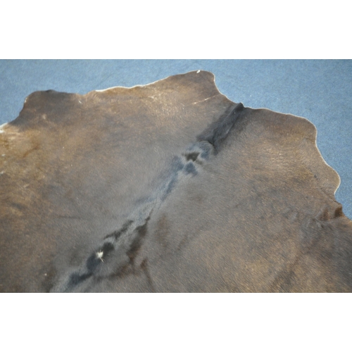 1320 - A HANLIN SOUTH AMERICAN NATURAL COWHIDE RUG, 160cm x 171cm (condition:-stitched repair to one area, ... 