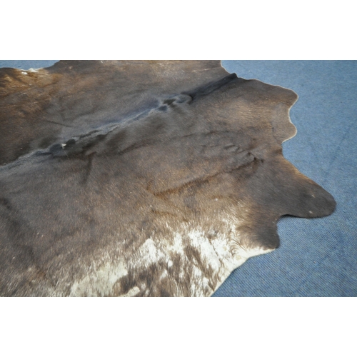 1320 - A HANLIN SOUTH AMERICAN NATURAL COWHIDE RUG, 160cm x 171cm (condition:-stitched repair to one area, ... 