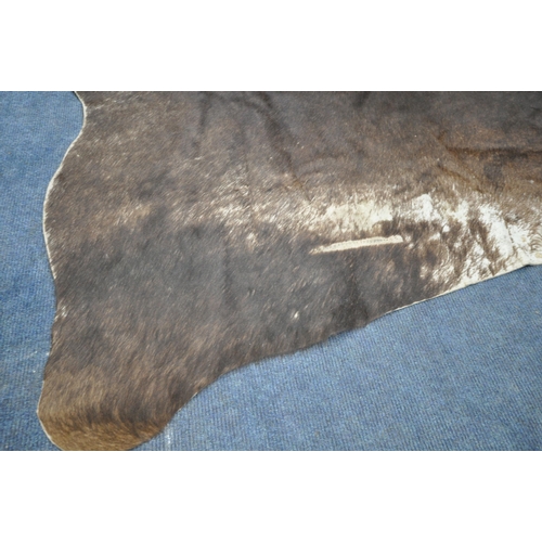 1320 - A HANLIN SOUTH AMERICAN NATURAL COWHIDE RUG, 160cm x 171cm (condition:-stitched repair to one area, ... 