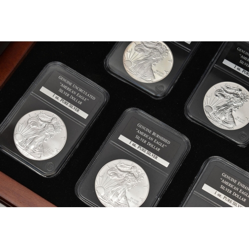 212 - A BOXED DISPLAY OF AMERICAN SILVER DOLLAR COINS, to include five different finishes genuine reverse ... 