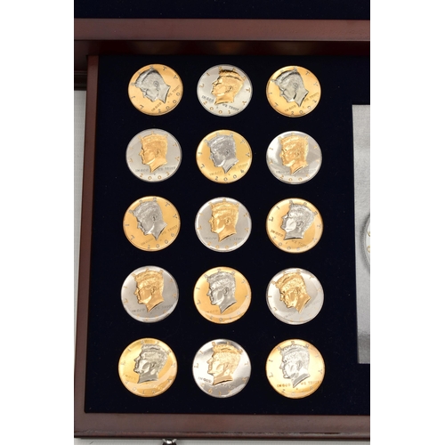 214 - A GLAZED BOXED SET OF ENHANCED KENNEDY HALF DOLLAR COINS, to include gold highlighted with uncircula... 