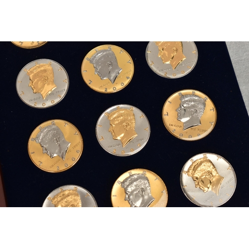 214 - A GLAZED BOXED SET OF ENHANCED KENNEDY HALF DOLLAR COINS, to include gold highlighted with uncircula... 