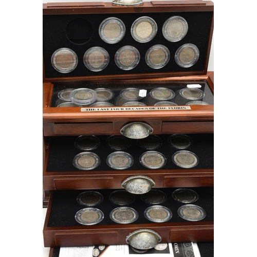 228 - A LARGE AND HEAVY BOX OF CASED UK COINAGE, to include the complete Shilling collection (58) 29 year ... 