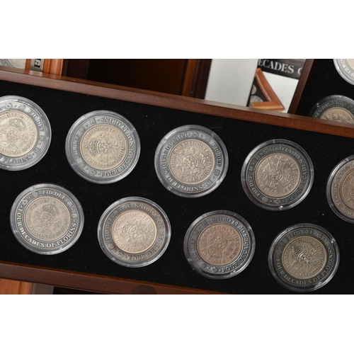 228 - A LARGE AND HEAVY BOX OF CASED UK COINAGE, to include the complete Shilling collection (58) 29 year ... 