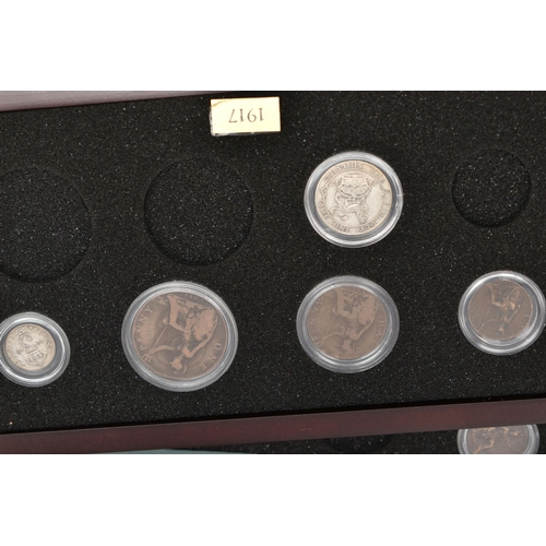 228 - A LARGE AND HEAVY BOX OF CASED UK COINAGE, to include the complete Shilling collection (58) 29 year ... 