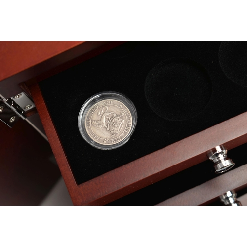 229 - A GLAZED DISPLAY BOX THREE DECADES of GEORGE V STAMP AND COIN SET, to include four trays of silver c... 