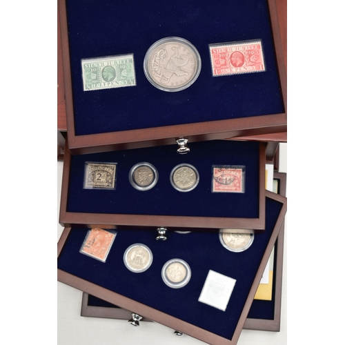 229 - A GLAZED DISPLAY BOX THREE DECADES of GEORGE V STAMP AND COIN SET, to include four trays of silver c... 