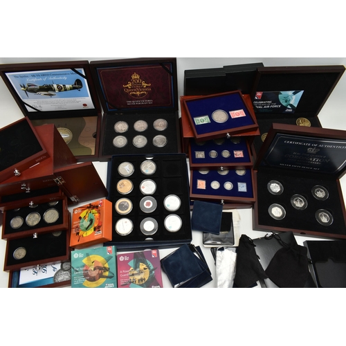 229 - A GLAZED DISPLAY BOX THREE DECADES of GEORGE V STAMP AND COIN SET, to include four trays of silver c... 