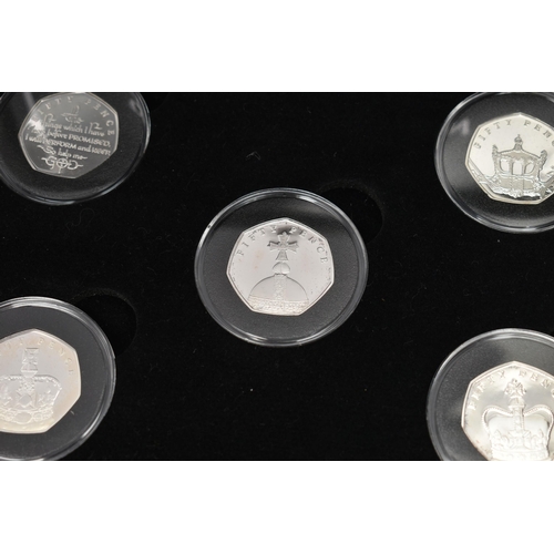 229 - A GLAZED DISPLAY BOX THREE DECADES of GEORGE V STAMP AND COIN SET, to include four trays of silver c... 