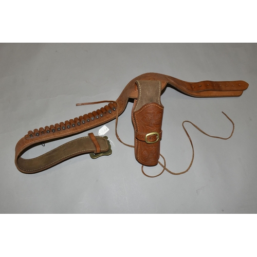 634 - A GOOD QUALITY HEAVILY TOOLED GUN BELT AND HOLSTER, with a number of inert cartridges