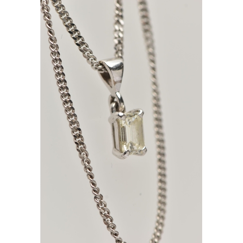 1 - A DIAMOND PENDANT NECKLACE, the emerald cut diamond within a four claw setting suspended from a curb... 