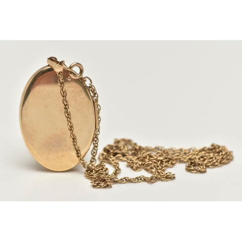 14 - A 9CT GOLD LOCKET AND CHAIN, oval locket with floral detail to the front, opens to reveal two compar... 