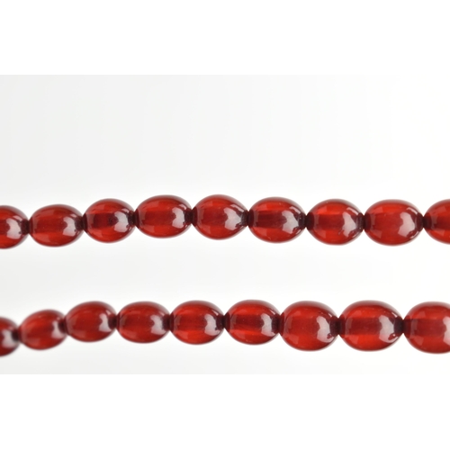 27 - A GRADUATED BAKELITE BEAD NECKLACE, comprising of sixty-nine beads measuring approximately 9mm to 29... 