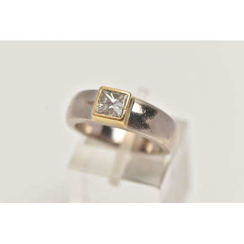 29 - A YELLOW AND WHITE METAL SINGLE STONE DIAMOND RING, princess cut diamond collet set in a yellow meta... 