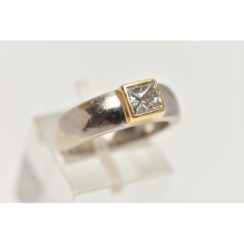 29 - A YELLOW AND WHITE METAL SINGLE STONE DIAMOND RING, princess cut diamond collet set in a yellow meta... 