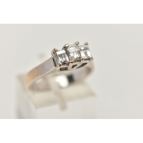 3 - AN 18CT GOLD THREE STONE DIAMOND RING, the tiered design claw set with three millennium cut diamonds... 